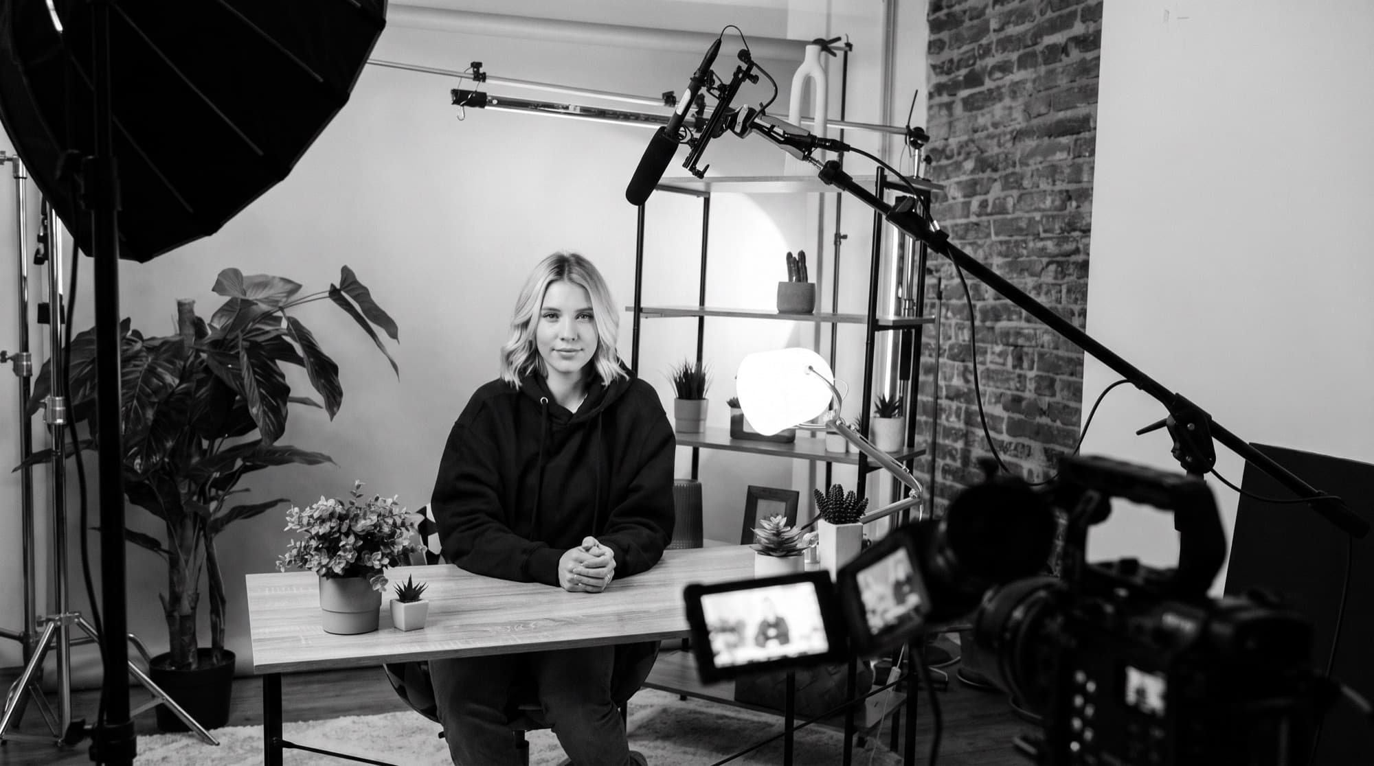 A creator filming behind the scenes in a professional studio setup